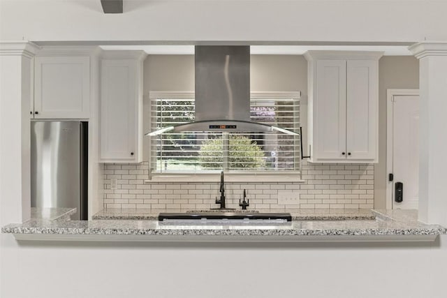 510 Heather Dr, Round Rock, TX 78664 - kitchen with island range hood, freestanding refrigerator, tasteful backsplash, and white cabinets