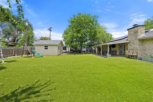 510 Heather Dr, Round Rock, TX 78664 - fenced backyard with a playground and a patio area