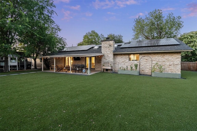 510 Heather Dr, Round Rock, TX 78664 - rear view of property with a chimney, roof mounted solar panels, and a patio area