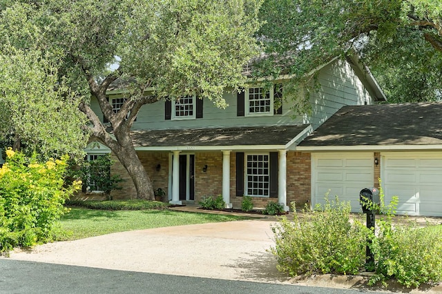 4009 Cordova Dr, Austin, TX 78759 - traditional-style home with covered porch, brick siding, roof with shingles, a garage, and concrete driveway