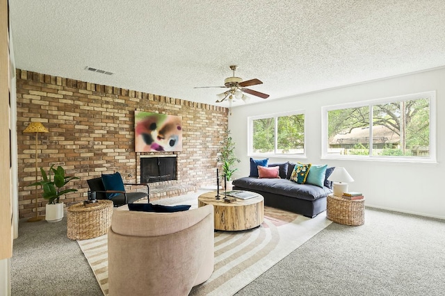 4009 Cordova Dr, Austin, TX 78759 - carpeted living room with ceiling fan, a fireplace, a textured ceiling, and brick wall