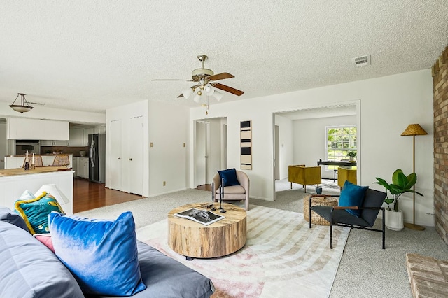 4009 Cordova Dr, Austin, TX 78759 - living room with a textured ceiling, a ceiling fan, and carpet flooring