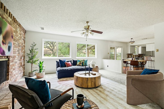 4009 Cordova Dr, Austin, TX 78759 - living room with a ceiling fan, light carpet, a textured ceiling, and a fireplace