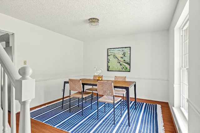 4009 Cordova Dr, Austin, TX 78759 - dining space featuring a textured ceiling and wood finished floors