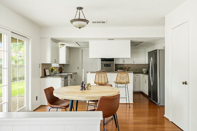 4009 Cordova Dr, Austin, TX 78759 - dining area featuring wood finished floors and a textured ceiling