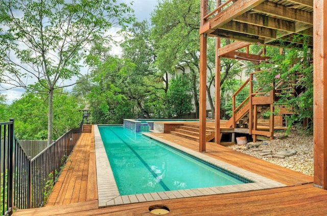 6605 Ladera Norte, Austin, TX 78731 - view of pool featuring a deck, a fenced backyard, stairway, and view of wooded area