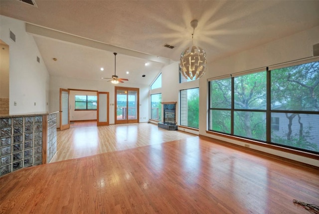 6605 Ladera Norte, Austin, TX 78731 - unfurnished living room featuring wood finished floors, a ceiling fan, high vaulted ceiling, and a fireplace