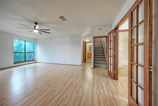 6605 Ladera Norte, Austin, TX 78731 - spare room with ceiling fan, light wood finished floors, and stairway