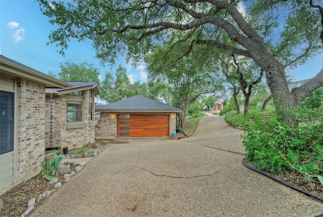 6605 Ladera Norte, Austin, TX 78731 - view of home's exterior with a garage and brick siding
