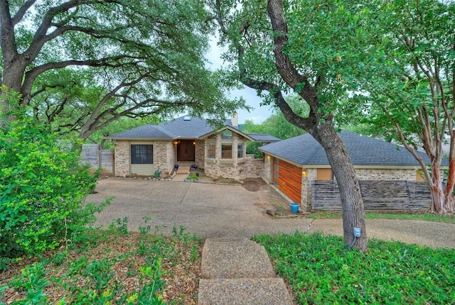 6605 Ladera Norte, Austin, TX 78731 - view of front of house featuring roof with shingles and brick siding