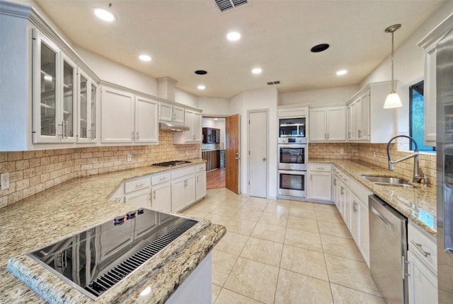 6605 Ladera Norte, Austin, TX 78731 - kitchen with stainless steel appliances, light stone counters, tasteful backsplash, and recessed lighting