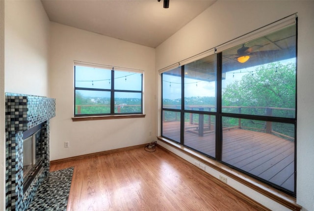 6605 Ladera Norte, Austin, TX 78731 - unfurnished living room featuring wood finished floors and a fireplace with flush hearth