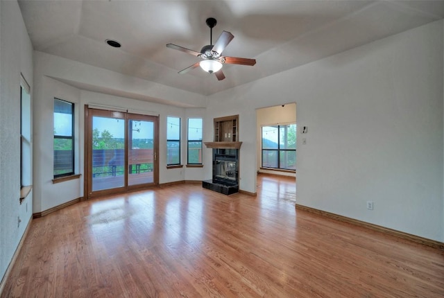 6605 Ladera Norte, Austin, TX 78731 - unfurnished living room with a ceiling fan, light wood-type flooring, and a multi sided fireplace