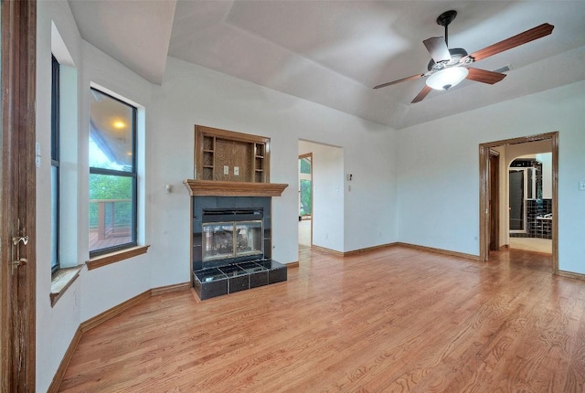 6605 Ladera Norte, Austin, TX 78731 - unfurnished living room featuring wood finished floors, a fireplace, and ceiling fan