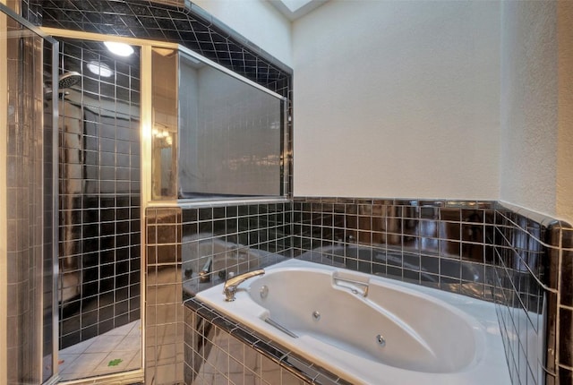 6605 Ladera Norte, Austin, TX 78731 - bathroom with a stall shower, a tub with jets, and a textured wall