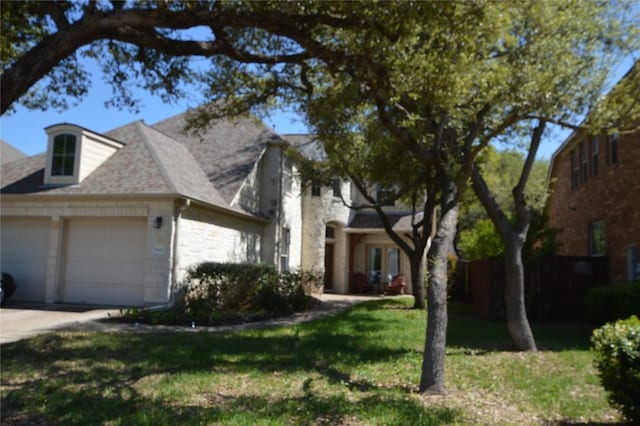 1802 Misty Ridge Dr, Leander, TX 78641 - view of front of home with an attached garage, stone siding, concrete driveway, and a front yard