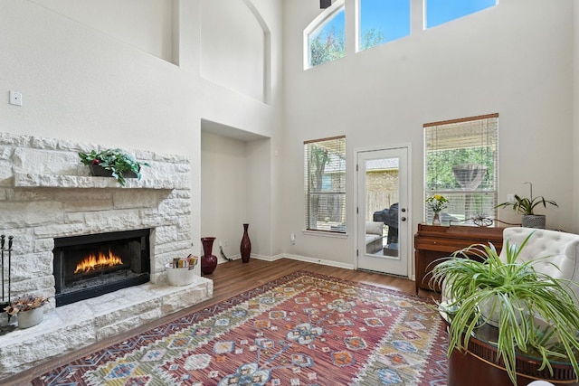 1802 Misty Ridge Dr, Leander, TX 78641 - living area featuring wood finished floors, a fireplace, and a towering ceiling