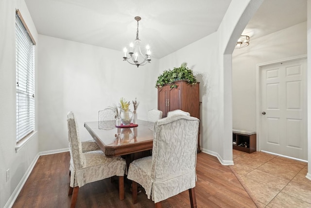 1802 Misty Ridge Dr, Leander, TX 78641 - dining space featuring a chandelier, arched walkways, and light wood-style floors