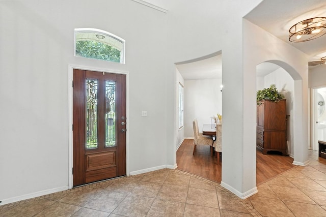 1802 Misty Ridge Dr, Leander, TX 78641 - entrance foyer featuring light tile patterned flooring, arched walkways, and a high ceiling