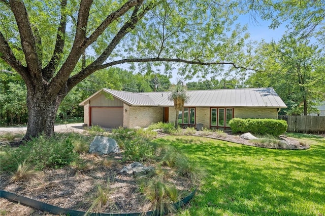 1407 Spring Gdn, Austin, TX 78746 - single story home with a garage, brick siding, a metal roof, a standing seam roof, and driveway