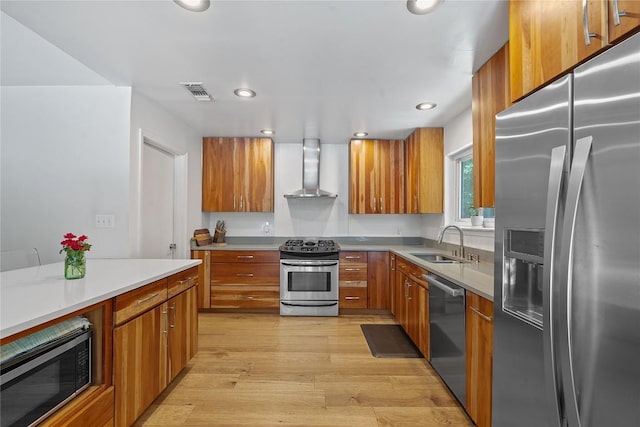 1407 Spring Gdn, Austin, TX 78746 - kitchen featuring appliances with stainless steel finishes, wall chimney exhaust hood, brown cabinets, modern cabinets, and light countertops