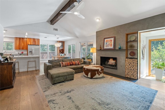 1407 Spring Gdn, Austin, TX 78746 - living room with light wood-type flooring, a large fireplace, and ceiling fan