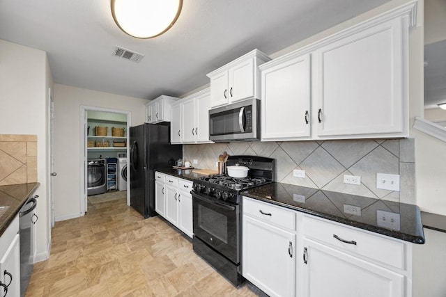 120 Hawkins Ct, Hutto, TX 78634 - kitchen featuring black appliances, separate washer and dryer, white cabinetry, dark stone counters, and tasteful backsplash