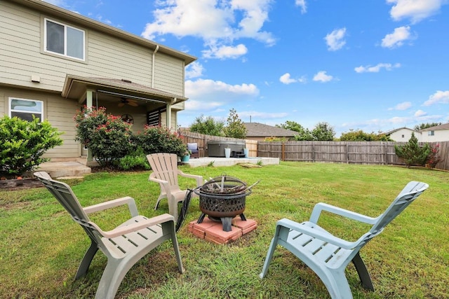 120 Hawkins Ct, Hutto, TX 78634 - fenced backyard with a fire pit, ceiling fan, and a patio
