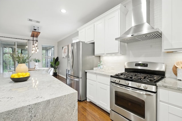 6116 Whipple Way, Austin, TX 78745 - kitchen with wall chimney exhaust hood, stainless steel appliances, light wood finished floors, ornamental molding, and white cabinets