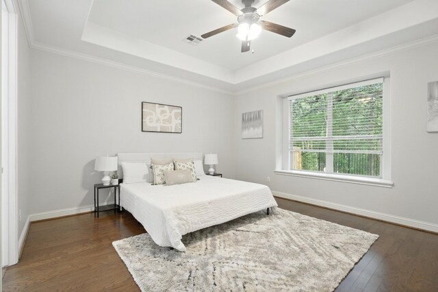 6116 Whipple Way, Austin, TX 78745 - bedroom featuring a tray ceiling, dark wood-type flooring, a ceiling fan, and crown molding