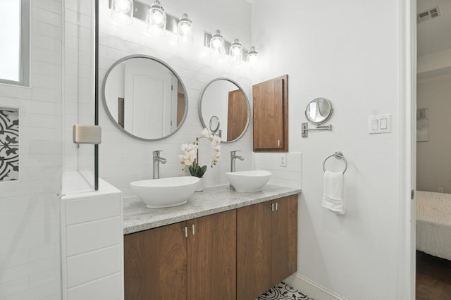 6116 Whipple Way, Austin, TX 78745 - ensuite bathroom featuring double vanity and tasteful backsplash