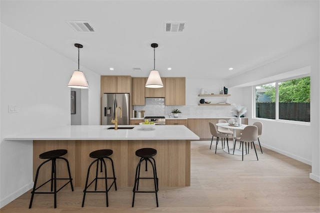 6721 Lost Vly, Austin, TX 78745 - kitchen featuring appliances with stainless steel finishes, a peninsula, modern cabinets, light countertops, and recessed lighting