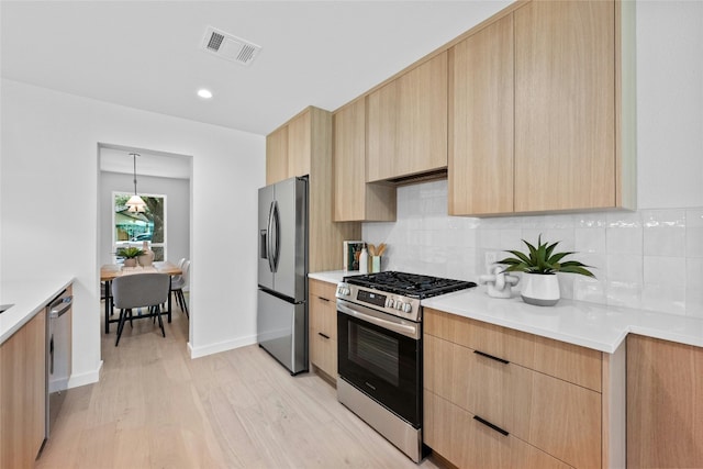 6721 Lost Vly, Austin, TX 78745 - kitchen featuring stainless steel appliances, light brown cabinetry, modern cabinets, and light wood-type flooring