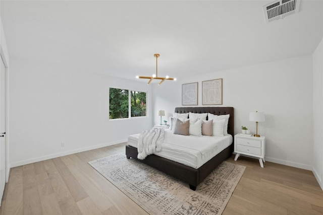 6721 Lost Vly, Austin, TX 78745 - bedroom with a chandelier and light wood finished floors