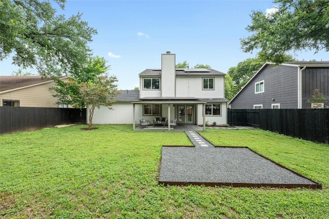 6721 Lost Vly, Austin, TX 78745 - back of property with a fenced backyard, solar panels, a patio area, and a chimney