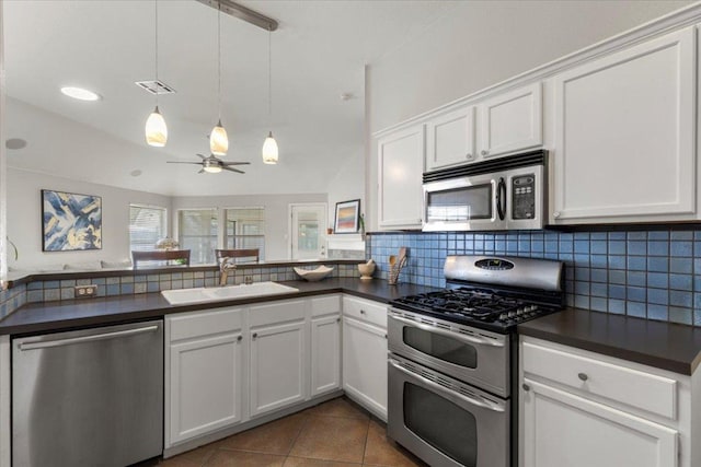 9012 Meacham Way, Austin, TX 78749 - kitchen featuring stainless steel appliances, dark countertops, backsplash, white cabinetry, and ceiling fan
