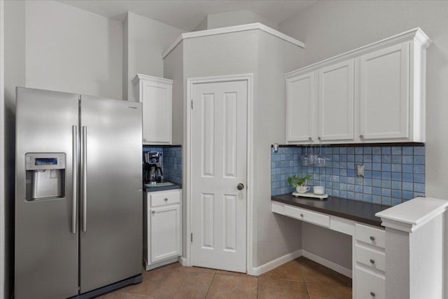 9012 Meacham Way, Austin, TX 78749 - kitchen featuring stainless steel refrigerator with ice dispenser, built in study area, white cabinets, and tile patterned flooring