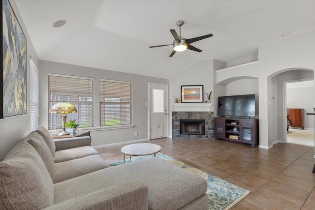 9012 Meacham Way, Austin, TX 78749 - living area featuring tile patterned flooring, a ceiling fan, lofted ceiling, a tiled fireplace, and arched walkways
