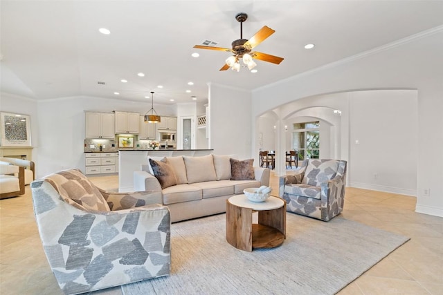 1500 El Cielo, Leander, TX 78641 - living room with arched walkways, light tile patterned flooring, a ceiling fan, recessed lighting, and ornamental molding