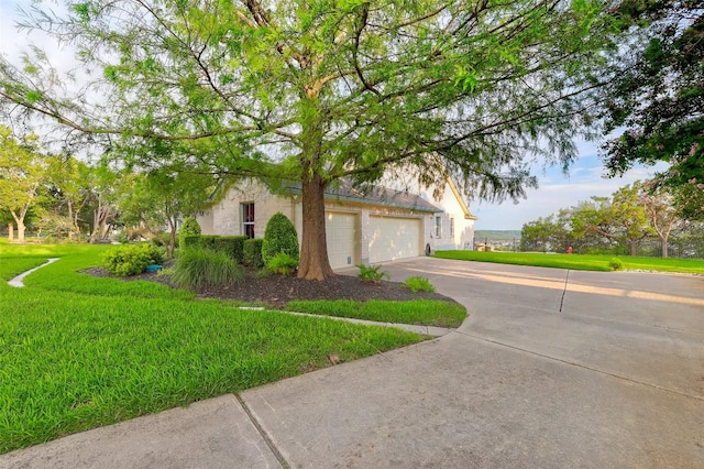 1500 El Cielo, Leander, TX 78641 - view of front of home with concrete driveway, an attached garage, a front lawn, and stucco siding