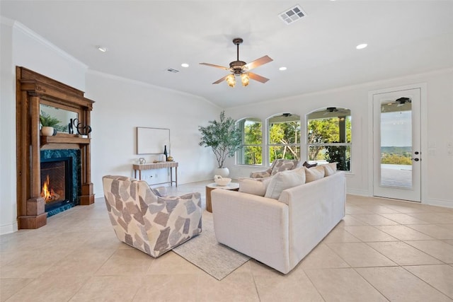 1500 El Cielo, Leander, TX 78641 - living area with light tile patterned flooring, a ceiling fan, crown molding, a high end fireplace, and recessed lighting