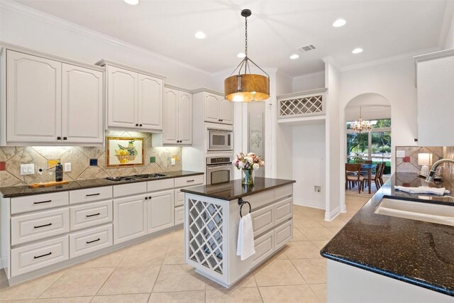 1500 El Cielo, Leander, TX 78641 - kitchen featuring stainless steel appliances, tasteful backsplash, pendant lighting, ornamental molding, and a chandelier
