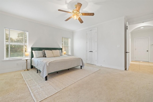 1500 El Cielo, Leander, TX 78641 - bedroom featuring arched walkways, light colored carpet, crown molding, a ceiling fan, and a closet