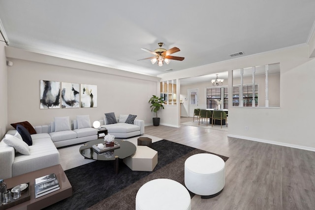 11705 Oak Trl, Austin, TX 78753 - living room with wood finished floors, a chandelier, ceiling fan, and crown molding