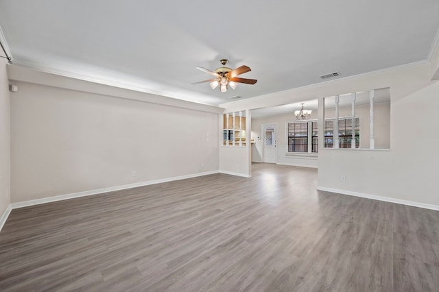 11705 Oak Trl, Austin, TX 78753 - unfurnished living room with a chandelier, a ceiling fan, wood finished floors, and ornamental molding