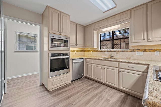 11705 Oak Trl, Austin, TX 78753 - kitchen featuring stainless steel appliances, light wood-type flooring, tasteful backsplash, and cream cabinetry
