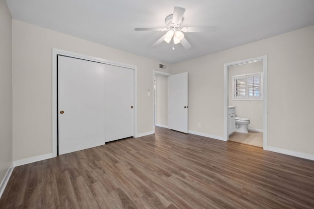 11705 Oak Trl, Austin, TX 78753 - unfurnished bedroom featuring a closet, wood finished floors, ensuite bathroom, and a ceiling fan