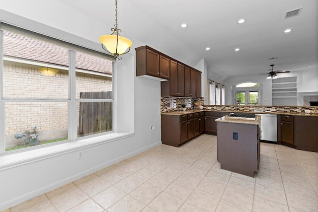 13121 Armaga Springs Rd, Austin, TX 78727 - kitchen featuring a ceiling fan, backsplash, appliances with stainless steel finishes, lofted ceiling, and dark brown cabinetry