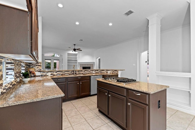 13121 Armaga Springs Rd, Austin, TX 78727 - kitchen featuring appliances with stainless steel finishes, ceiling fan, light tile patterned flooring, light stone counters, and recessed lighting