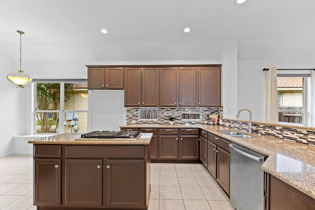 13121 Armaga Springs Rd, Austin, TX 78727 - kitchen featuring appliances with stainless steel finishes, light tile patterned flooring, tasteful backsplash, light stone countertops, and recessed lighting